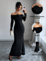 A woman modeling a black off-the-shoulder long-sleeve maxi dress with a large three-dimensional flower detail at the neckline, shown in a mirror selfie style. Three circular callout graphics on the right highlight the flower detail, the back fit, and the fitted fishtail silhouette.