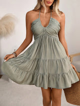 Woman wearing a green dress with a neutral background