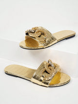 Pair of gold sandals with decorative straps on a white background
