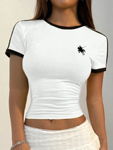 White t-shirt with black trim and logo worn by a person on a neutral background
