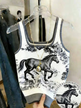 Tank top with horse print on a hanger in a store setting