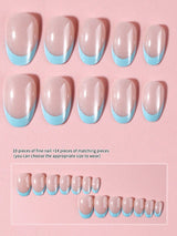 Ten false press-on nails with a nude-pink top and a light blue French tip, displayed on a pink background with size text and smaller size reference thumbnails.