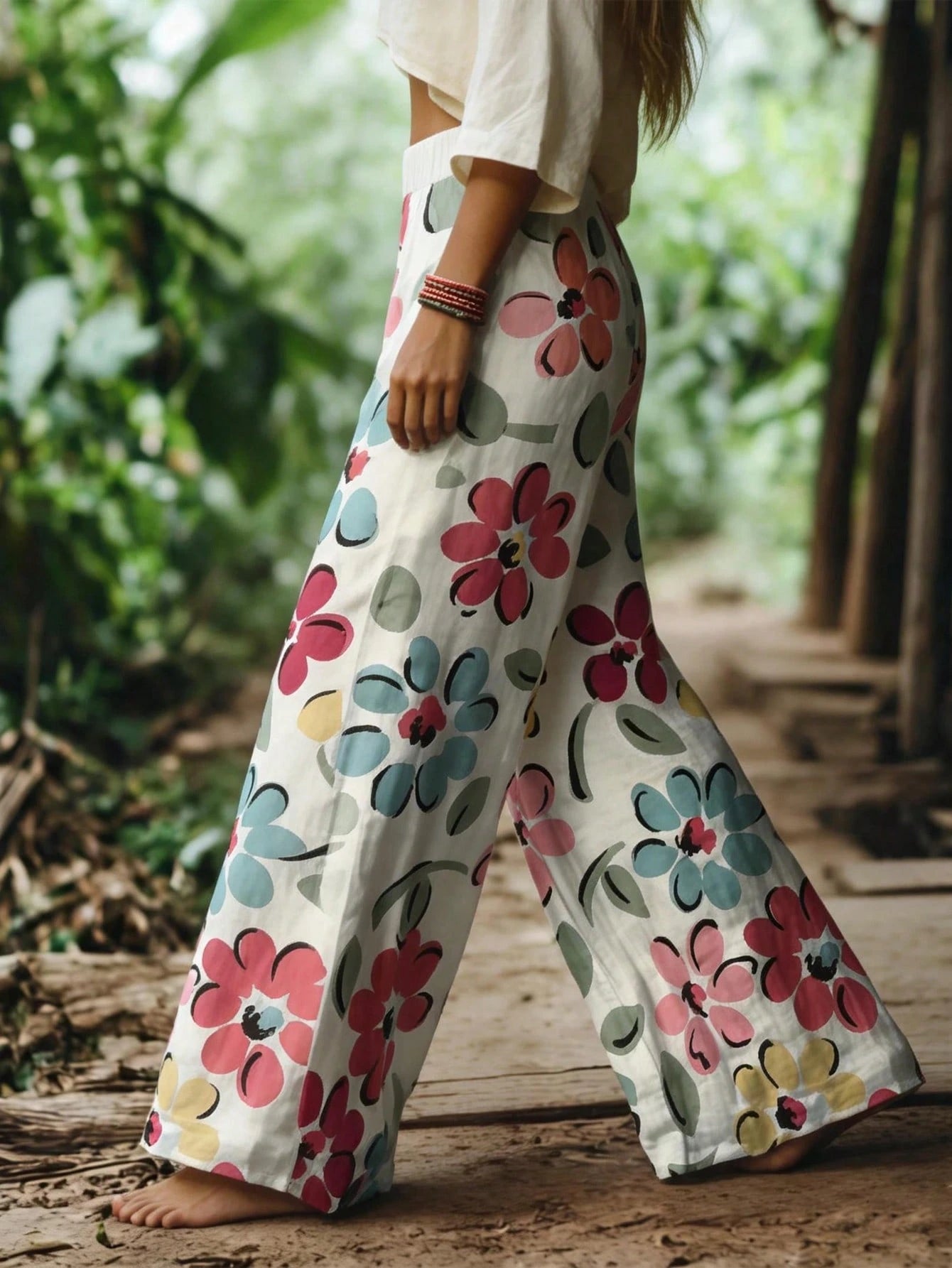Person wearing floral-patterned pants standing in a natural setting