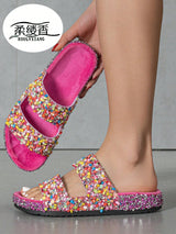 Colorful slippers with pink sole held by a hand, brand 'Koulyxiang' visible.